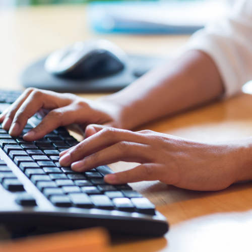 Hands typing on keyboard